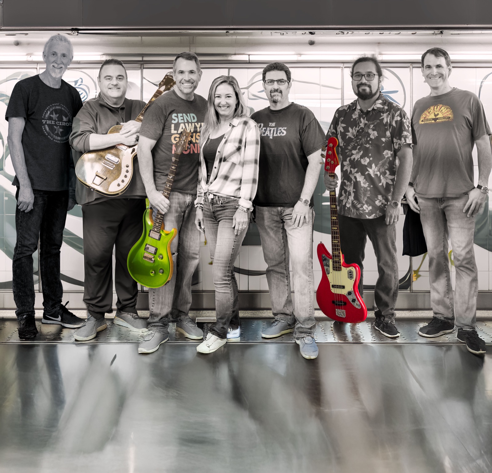 The seven members of Hall Pass standing together, two holding guitars